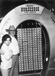 Benny Binion and daughter, with his $1 million collection (of money in a horseshoe).